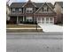 Charming two-story brick home with a well-manicured lawn and an attached two-car garage at 3299 Arbor Oaks Dr, Snellville, GA 30039