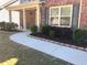 Inviting walkway leading to the front door, surrounded by neatly landscaped flower beds and lush green grass at 3299 Arbor Oaks Dr, Snellville, GA 30039