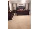 Elegant primary bedroom features a tray ceiling, plush carpet, and ornate dark wood furniture at 3299 Arbor Oaks Dr, Snellville, GA 30039
