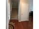 View of the staircase and a coat closet inside the main entrance, featuring hardwood floors at 3299 Arbor Oaks Dr, Snellville, GA 30039