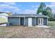 Back exterior featuring a backyard with blue siding and double doors at 3918 S Creek Ct, Stone Mountain, GA 30083
