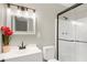 Stylish bathroom with a vanity, framed mirror, modern lighting, and glass-enclosed shower at 558 Newlin Ct, Lawrenceville, GA 30046