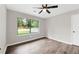 This bedroom is bright and airy with laminate flooring and a window overlooking the front yard at 558 Newlin Ct, Lawrenceville, GA 30046