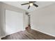A bright bedroom with a ceiling fan, nice hardwood floors, and a closet at 558 Newlin Ct, Lawrenceville, GA 30046