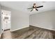 Bedroom with laminate flooring, ceiling fan, and entrance to the ensuite bathroom at 558 Newlin Ct, Lawrenceville, GA 30046