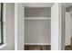 A bright closet with white shelving and rail behind opened doors at 558 Newlin Ct, Lawrenceville, GA 30046
