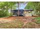 Back exterior view of a house surrounded by trees at 558 Newlin Ct, Lawrenceville, GA 30046