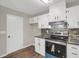 Well-equipped kitchen featuring modern appliances, stylish backsplash, and convenient access to the backyard at 558 Newlin Ct, Lawrenceville, GA 30046