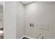 Bright laundry room featuring white walls, laminate flooring and hookups for washer and dryer at 558 Newlin Ct, Lawrenceville, GA 30046
