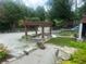 The spacious gravel backyard features a pergola and lush landscaping at 1570 Cedars Rd, Lawrenceville, GA 30045