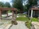 This backyard offers a pergola, synthetic grass, a playhouse, a deck, and beautiful landscaping at 1570 Cedars Rd, Lawrenceville, GA 30045