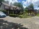 This backyard offers a patio, pergola, playhouse, a deck, and is nicely landscaped at 1570 Cedars Rd, Lawrenceville, GA 30045