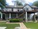 View of the deck and stairs from the home's brick patio with well-maintained landscaping at 1570 Cedars Rd, Lawrenceville, GA 30045