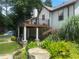 View of the home's deck and landscaped backyard with lush lawn and garden at 1570 Cedars Rd, Lawrenceville, GA 30045