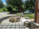 View of the gravel and landscaped backyard featuring a stone firepit and playground at 1570 Cedars Rd, Lawrenceville, GA 30045