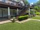 This backyard offers a deck with stairs, a brick walkway, synthetic grass, and attractive landscaping at 1570 Cedars Rd, Lawrenceville, GA 30045
