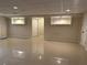 Large open basement area with tiled floors and recessed lighting throughout at 1570 Cedars Rd, Lawrenceville, GA 30045