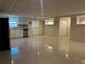 Finished basement area with kitchenette, white cabinets, and tile flooring at 1570 Cedars Rd, Lawrenceville, GA 30045