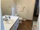 Bathroom featuring a vanity with sink, toilet, and a tile shower at 1570 Cedars Rd, Lawrenceville, GA 30045
