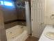 Bathroom featuring a bathtub and shower, a toilet, and a vanity with sink at 1570 Cedars Rd, Lawrenceville, GA 30045
