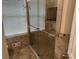 Bathroom featuring a glass-enclosed shower and tiled walls at 1570 Cedars Rd, Lawrenceville, GA 30045