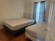 Cozy bedroom with two beds and a patterned curtain at 1570 Cedars Rd, Lawrenceville, GA 30045
