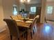 Dining area featuring hardwood floors and an open-concept design to the kitchen and living area at 1570 Cedars Rd, Lawrenceville, GA 30045