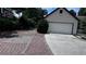 Long driveway leading to a two-car garage, featuring a unique brick design at 1570 Cedars Rd, Lawrenceville, GA 30045