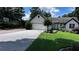 Attractive single-story home features a well-manicured lawn, mature landscaping, and a two-car garage at 1570 Cedars Rd, Lawrenceville, GA 30045