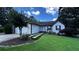 Inviting single-story home with a well-manicured lawn and a unique walkway to the front door at 1570 Cedars Rd, Lawrenceville, GA 30045