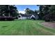 Lush green lawn with a charming single-story home and mature trees providing shade at 1570 Cedars Rd, Lawrenceville, GA 30045