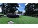 Beautifully landscaped front yard with mature trees, a lush green lawn, and a basketball hoop at 1570 Cedars Rd, Lawrenceville, GA 30045