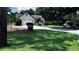 Inviting single-story home with a large, well-maintained front lawn and mature trees at 1570 Cedars Rd, Lawrenceville, GA 30045