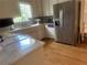 Bright kitchen features white cabinets, stainless steel appliances, and marble countertops at 1570 Cedars Rd, Lawrenceville, GA 30045