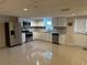 The updated kitchen features stainless steel appliances and tile flooring at 1570 Cedars Rd, Lawrenceville, GA 30045