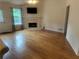 Bright living room featuring a fireplace, hardwood floors, and access to the backyard at 1570 Cedars Rd, Lawrenceville, GA 30045