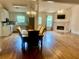 Open-concept living and dining areas featuring hardwood floors, neutral walls, and fireplace at 1570 Cedars Rd, Lawrenceville, GA 30045