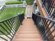 Exterior staircase with black railings and wooden steps leads to outdoor living areas at 1570 Cedars Rd, Lawrenceville, GA 30045