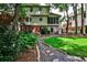 Backyard with a stone pathway, lush lawn, mature trees, a screened in porch, and a brick foundation at 3747 Sturbridge Ct, Tucker, GA 30084
