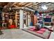 Unfinished basement featuring exposed ductwork, a large rug, and various storage items at 3747 Sturbridge Ct, Tucker, GA 30084