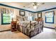 Bedroom with neutral carpet, cream walls, blue trim, and a metal bed frame at 3747 Sturbridge Ct, Tucker, GA 30084