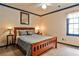 Bedroom with a wooden bed frame, neutral walls, blue trim, and neutral carpet at 3747 Sturbridge Ct, Tucker, GA 30084