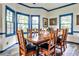 Bright and airy dining room with a large wooden table, plenty of seating, and blue trim at 3747 Sturbridge Ct, Tucker, GA 30084