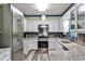 Modern kitchen with stainless steel appliances, granite countertops, and white cabinetry at 3747 Sturbridge Ct, Tucker, GA 30084