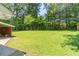 Spacious backyard with lush green grass and mature trees at 4077 Phils Ct, Tucker, GA 30084