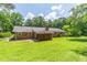 Expansive backyard featuring a well-maintained lawn and a covered patio, perfect for outdoor living at 4077 Phils Ct, Tucker, GA 30084