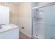 This bathroom has wallpapered walls, a tiled floor, a sink, and a glass enclosed shower at 4077 Phils Ct, Tucker, GA 30084