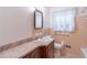 Traditional bathroom featuring a vanity with a marble countertop and a vintage mirror at 4077 Phils Ct, Tucker, GA 30084