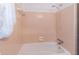 Retro bathroom with a corner tub and shower combination, featuring classic pink tiling at 4077 Phils Ct, Tucker, GA 30084