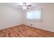 This bedroom has a ceiling fan and hardwood floors at 4077 Phils Ct, Tucker, GA 30084